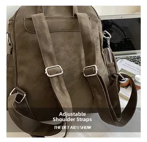 Detail view of adjustable straps and metal buckles on dark brown vintage backpack