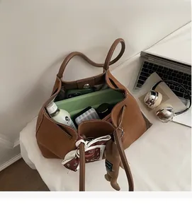 Detailed interior of brown suede tote bag showing large capacity and decorative silk scarf