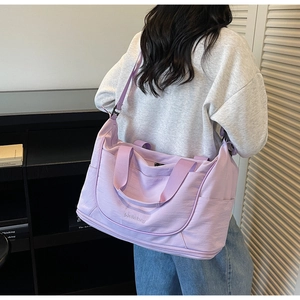 Lavender travel duffel bag detail showing high-density nylon fabric and shoe compartment