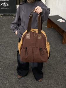 Waterproof nylon backpack in brown and ginger yellow with drawstring front pocket