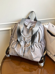 Waterproof grey-purple nylon backpack with drawstring pockets and top handle straps