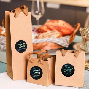 Three sizes of brown kraft paper gift bags with black Thank You for Business labels