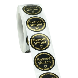 Roll of black and gold handmade with love stickers featuring elegant heart design