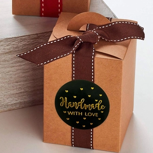 Roll of black and gold round stickers with 'Handmade with Love' on a gift box