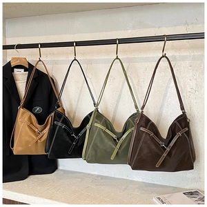 Detail of vintage soft leather tote bags in four colors showing stitching and strap buckles