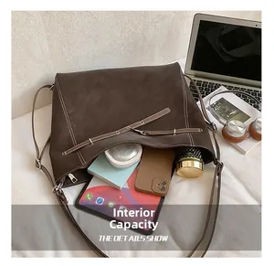Detail view of deep brown suede tote bag showing large interior capacity for daily essentials
