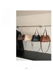 Row of large vintage tote bags in dark brown, beige, black, and reddish-brown with bow detail