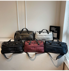 Collection of nylon duffel bags in five colors with reinforced handles and cross-body straps