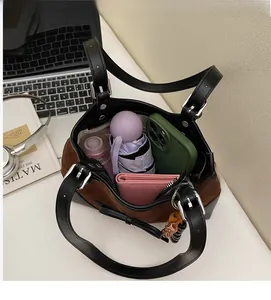 Top view of spacious contrast suede handbag showing storage for phone and wallet