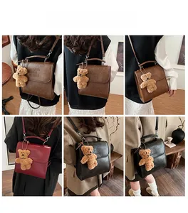 Detailed views of vintage box backpack in brown, burgundy, and black with plush bear charm