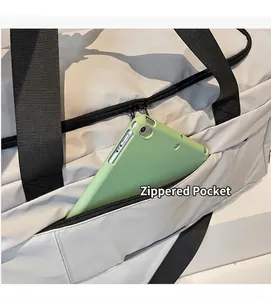 Detailansicht der seitlichen Reißverschlusstasche an einer Reisetasche mit grünem Tablet