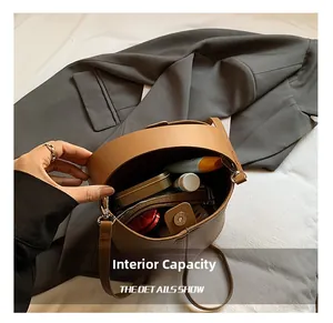 Macro view of large capacity dark brown bucket bag showing interior cosmetics storage
