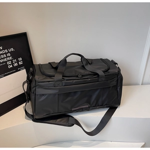 Detail of a black sports gym bag with waterproof fabric and adjustable shoulder strap