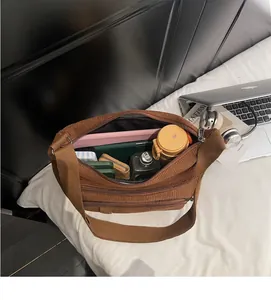 Interior view of large capacity brown corduroy tote bag showing organized daily items
