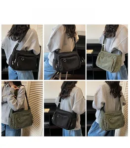 Close-up of black and army green canvas tote bags showing side pockets and fabric texture