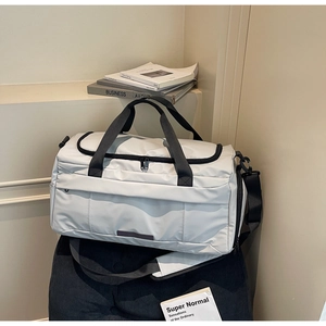 Detail of light grey sports gym bag with black straps and adjustable shoulder belt
