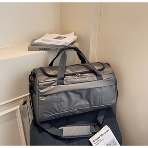 Detail of high-capacity travel bag featuring water-resistant fabric and reinforced handles