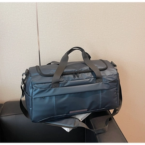 Detail of navy blue waterproof nylon travel bag with dual zippers and reinforced handles
