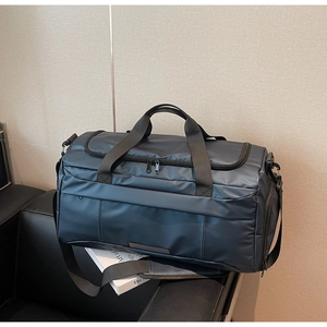 Detailed view of dark blue gym bag with waterproof nylon fabric on leather seat
