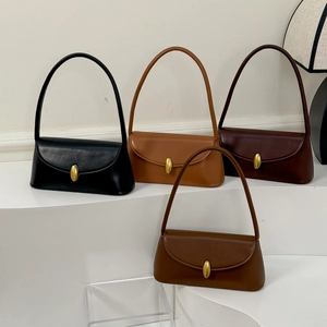 Detail of four retro baguette bags in earthy colors with signature gold oval metal clasps