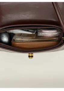 Internal view showing the spacious storage capacity of the dark brown leather shoulder bag