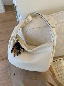 Retro cream faux leather hobo bag with pebble texture and chic beaded accessory