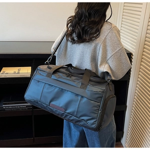 Detailed view of the large navy blue fitness travel bag with multiple compartments