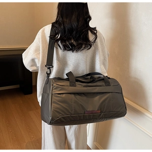 Close-up of a large dark grey gym bag with durable nylon texture and adjustable strap