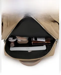 Interior view of khaki canvas backpack showing organized compartments and large capacity