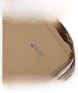 Detail shot of khaki fabric texture with silver rabbit logo and patterned strap