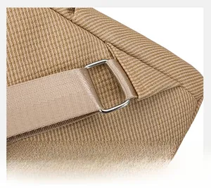Detail of silver metal D-ring and thick nylon strap on khaki canvas backpack