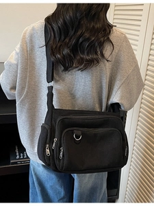 Fashionable black corduroy tote bag with adjustable strap and multiple pockets