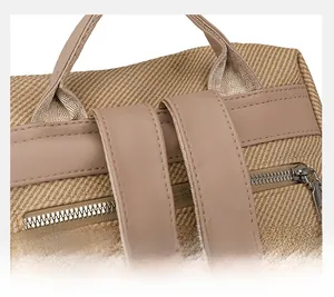 Detail of khaki canvas backpack showing fine double stitching and premium metal zipper