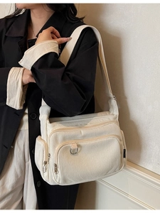 Fashionable cream corduroy tote bag with silver zippers and wide shoulder strap
