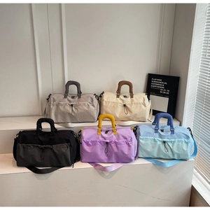 Detailed view of lightweight travel bags in five colors with honeycomb texture and strap