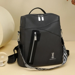 Detail of black backpack with unique geometric patterned shoulder strap and fine texture