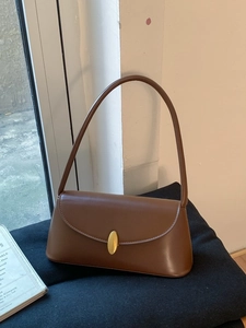 Vintage dark brown faux leather underarm shoulder bag with a gold oval metal clasp