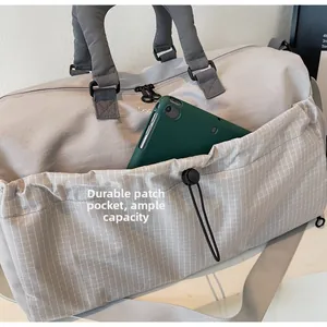 Close-up of durable grey mesh pocket on travel bag showing spacious storage for tablets