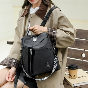 Close-up of black textured backpack with a geometric pattern strap and rabbit logo detail