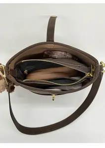 Internal view of brown leather bucket bag showing large capacity and zipper pocket