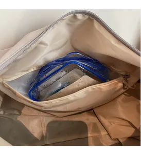Detail of waterproof dry-wet separation compartment in beige travel duffel bag