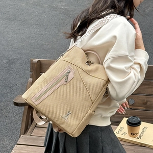 Close-up of woven texture backpack with kangaroo metal logo and jacquard strap