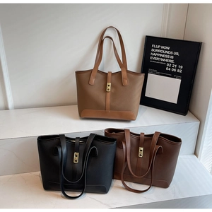 Minimalist tote bags in brown and black with litchi grain texture and gold buckles