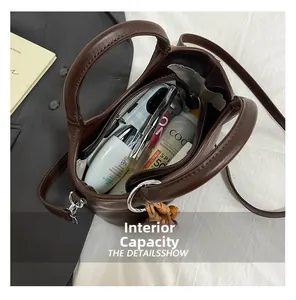 Top-down view of brown leather bucket bag showing spacious interior with daily essentials