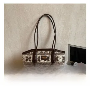 Close-up of brown and beige jacquard plush tote bag with premium leather straps