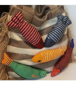 Detailed view of colorful woven fish charms in assorted patterns and textured fabrics