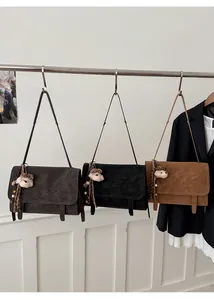 Three vintage matte leather tote bags in dark grey, black, and brown with cute bear charms