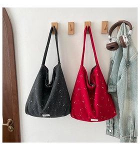 Detail of red and grey star pattern canvas tote bags with vintage woven labels