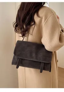 Retro large capacity crossbody messenger bag shown on model in winter wool coat