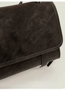 Close-up of the matte soft-mist leather texture and neat stitching on a vintage square bag